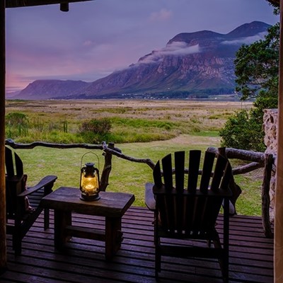DUSK, CHAIR, DECKING, WOOD, SERENE, VIEW, MOUNTAIN, LANTERN, GRASS, SPARSE, TREE, CLOUD