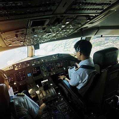 COCKPIT, SEATBELT, CONTROLS, CITYSCAPE, SCREENS, PILOT, HEADSET, BUTTONS, SWITCHES, AIRCRAFT, PANEL