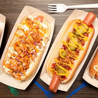 HOTDOG, PICKLES, ONIONS, TRAY, SNACK, CARDBOARD, BUN, MUSTARD, FORK, TOPPINGS, SAUCE, FASTFOOD