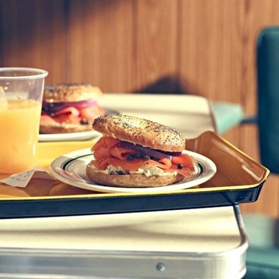 JUICE, POPPYSEEDS, PLATE, BREAKFAST, PLASTIC, BAGEL, SALMON, TRAY, RECEIPT, TABLE, CAPERS