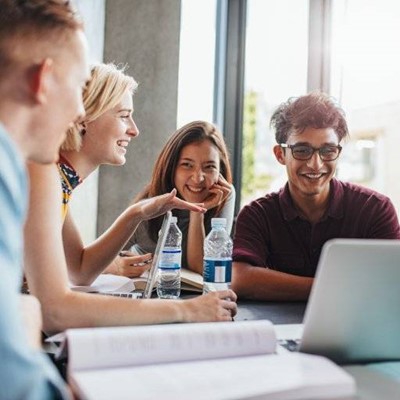 GROUP, STUDENTS, LAPTOP, BOTTLES, SMILING, BOOK, PAGES, WATER, GLASSES, WINDOW, UNIVERSITY